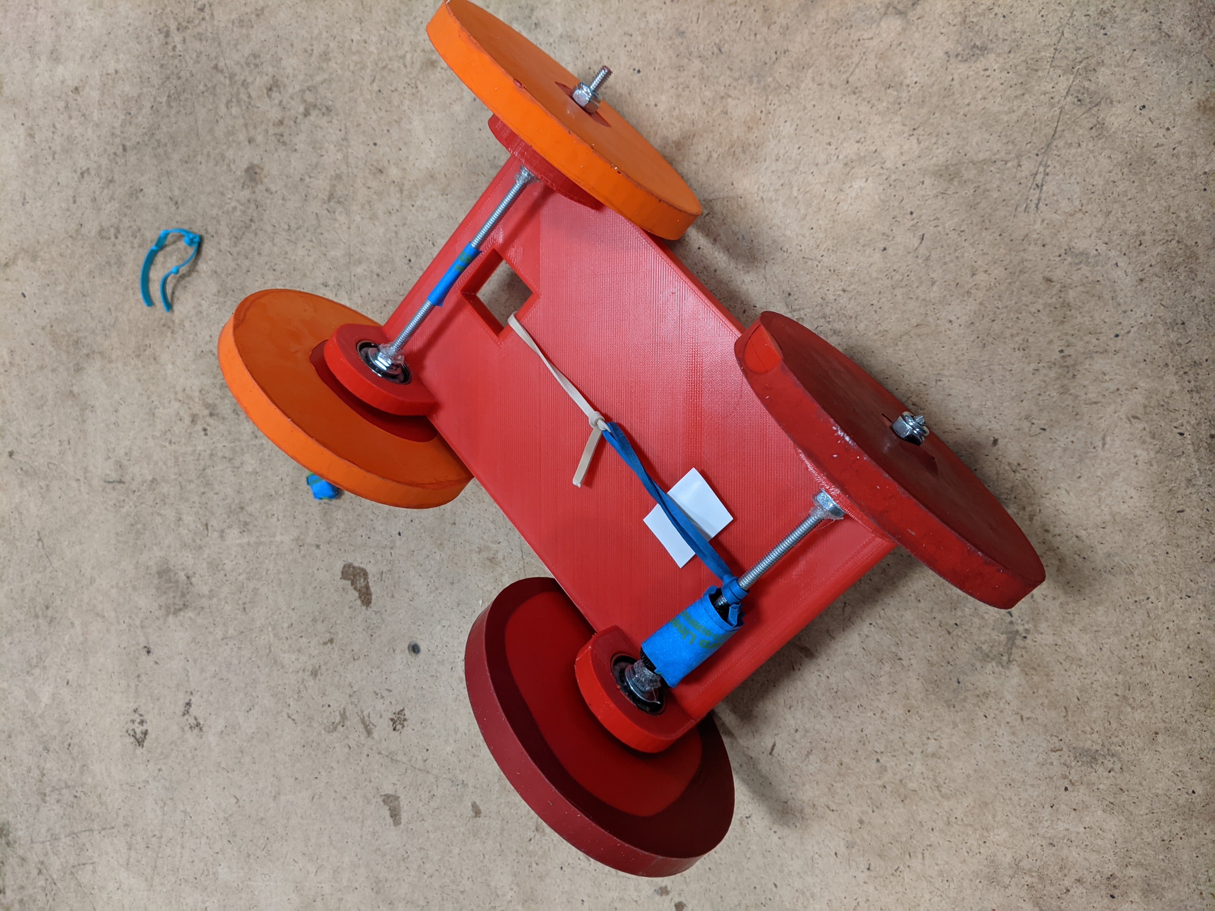 A 3D printed car with a metal axis rotated by a rubber band