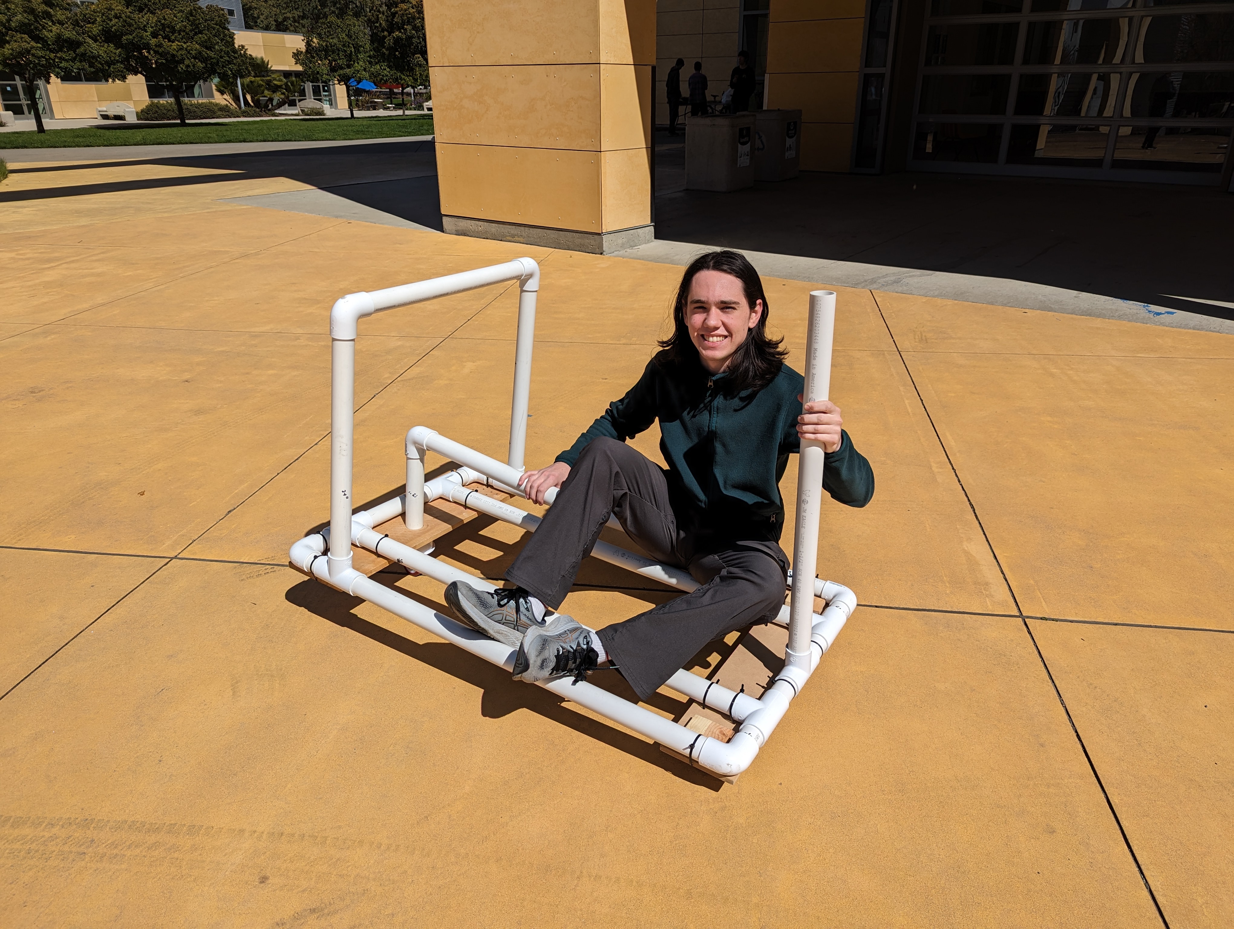 Garrett riding a PVC cart